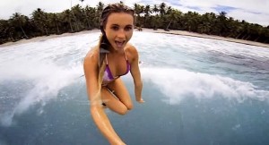 Woman in bikini jumping in water gopro camera
